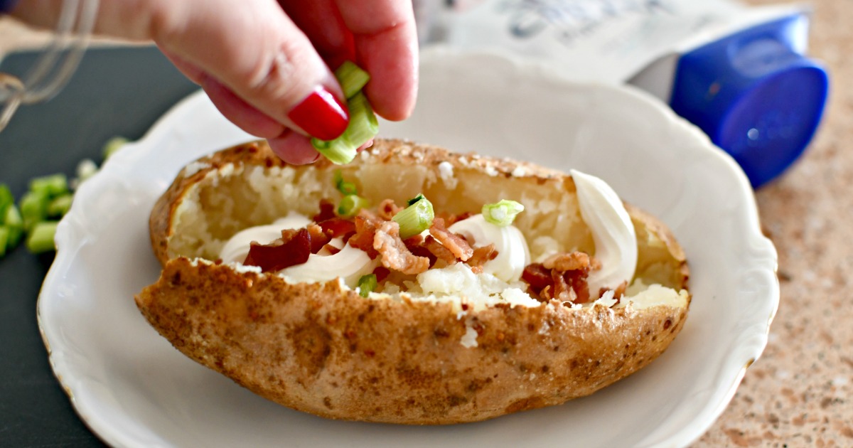 putting toppings on a baked potato 