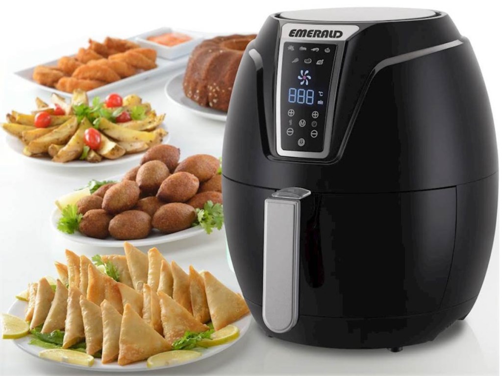 emerald air fryer with plates of fried food 