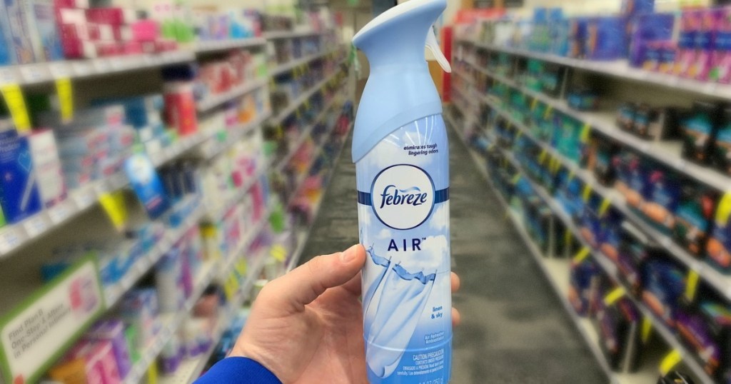 hand holding bottle of air freshener in the store