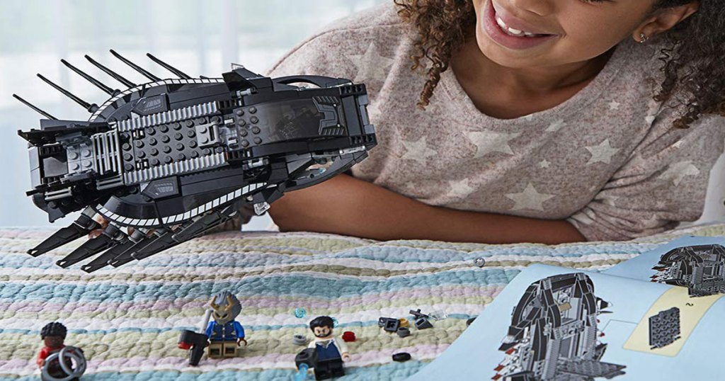 girl playing with the LEGO Marvel Super Heroes Royal Talon Fighter Attack set