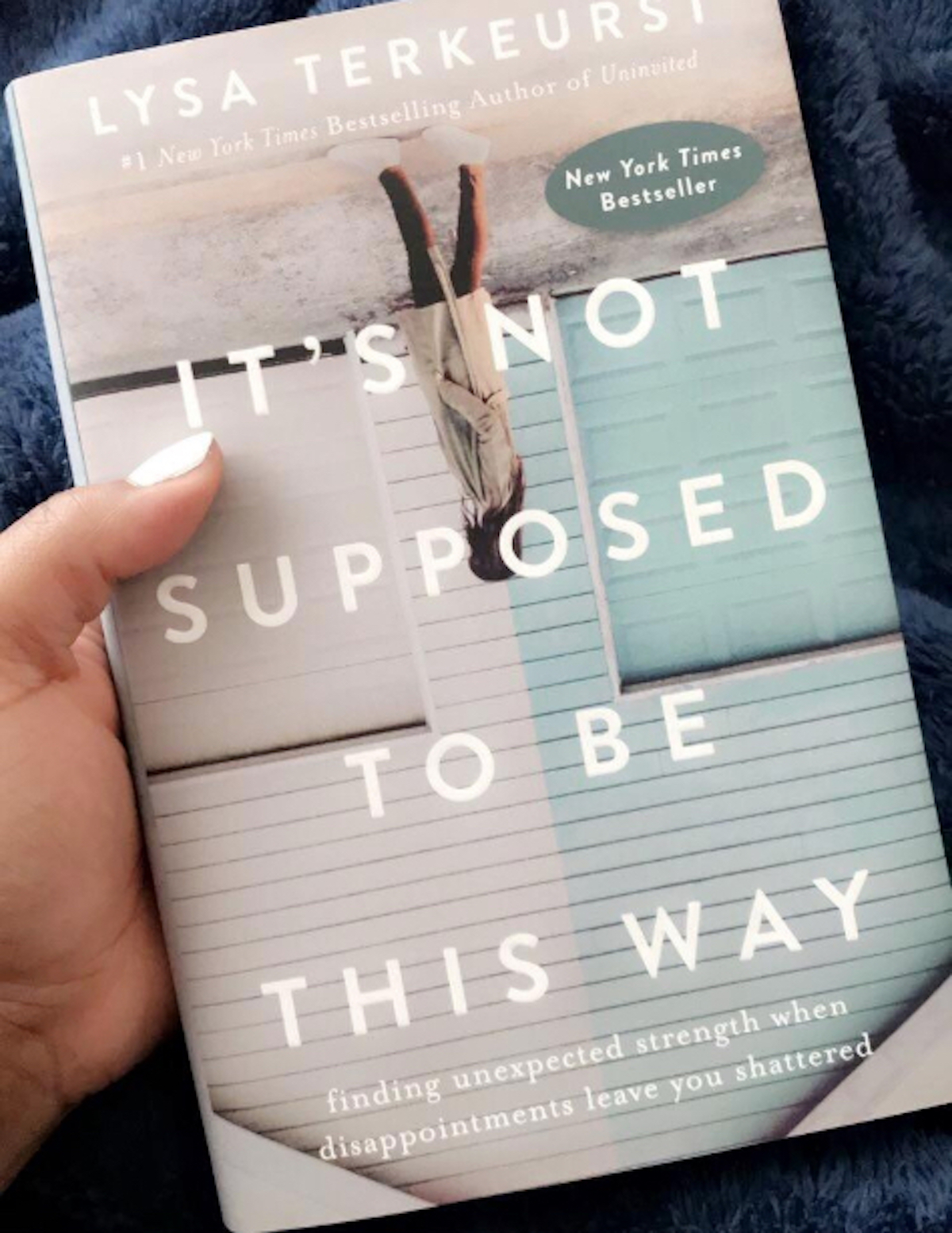 hand holding it's not supposed to be this way book 