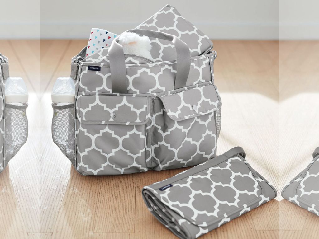 grey and white Carryall Tote Diaper Bag on hardwoord