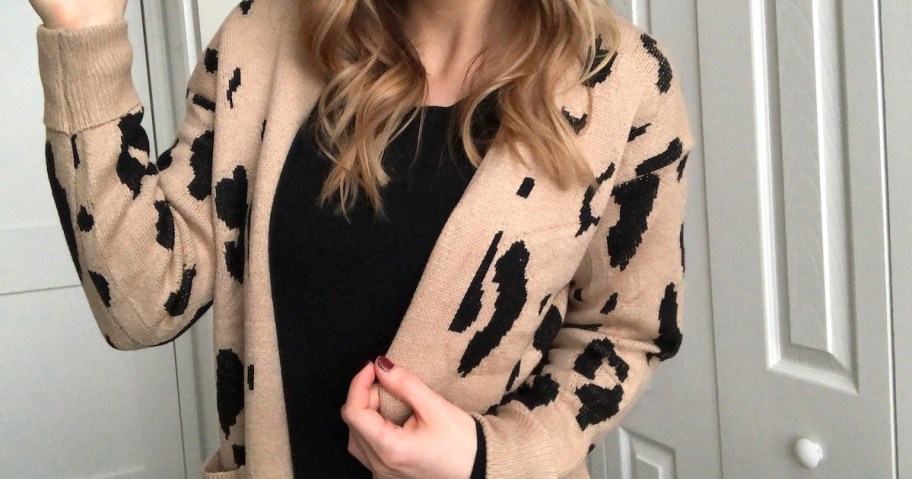 woman wearing black and beige leopard cardigan with black shirt