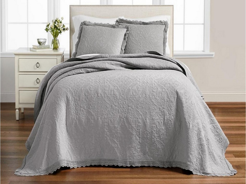 gray comfort with gray shams on bed