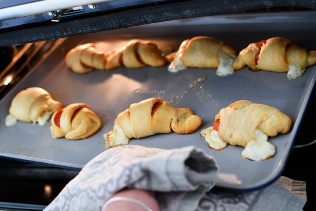 pizza crescents on a sheet pan in the oven