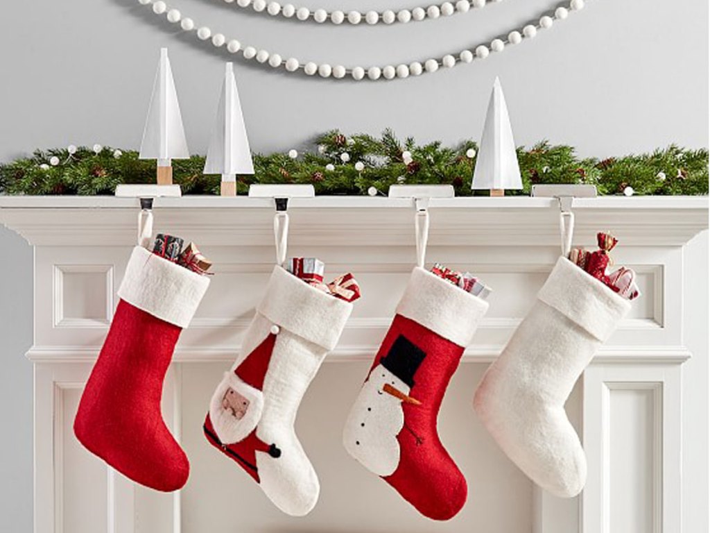 pottery barn modern stockings hanging on a fireplace mantle