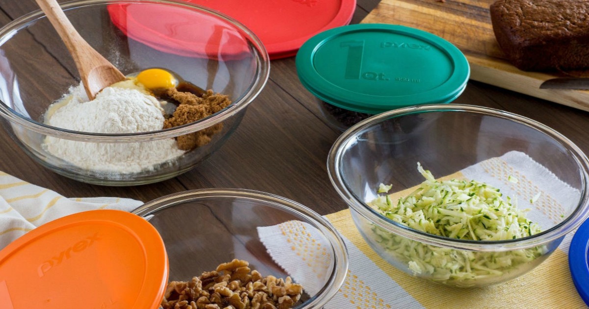 Pyrex glass bowls with colorful lids on a table