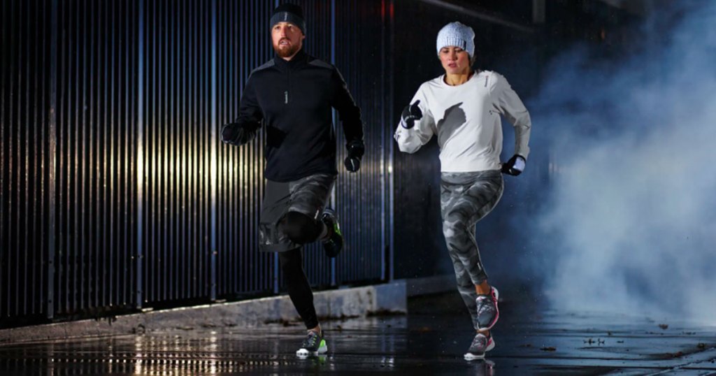 man and woman running in reeboks in the cold night