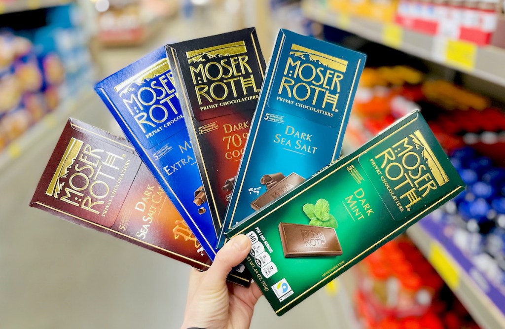 hand holding a fan of roth moser chocolate bars in store aisle