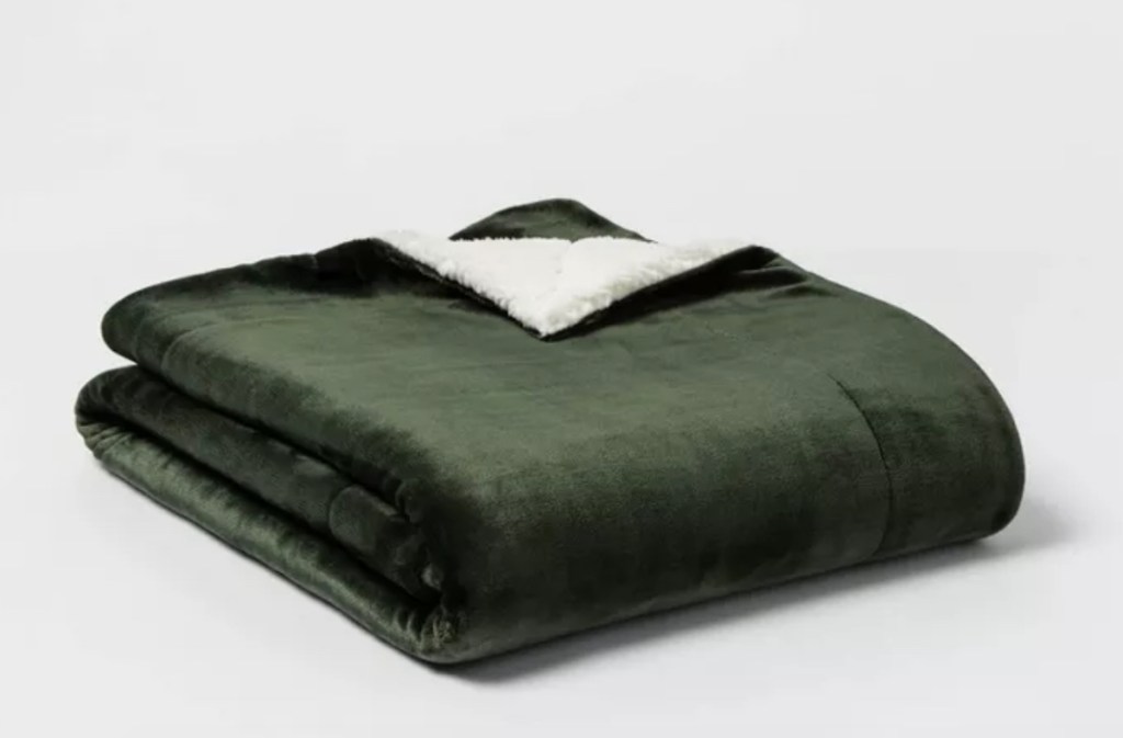 stock photo of folded dark green blanket