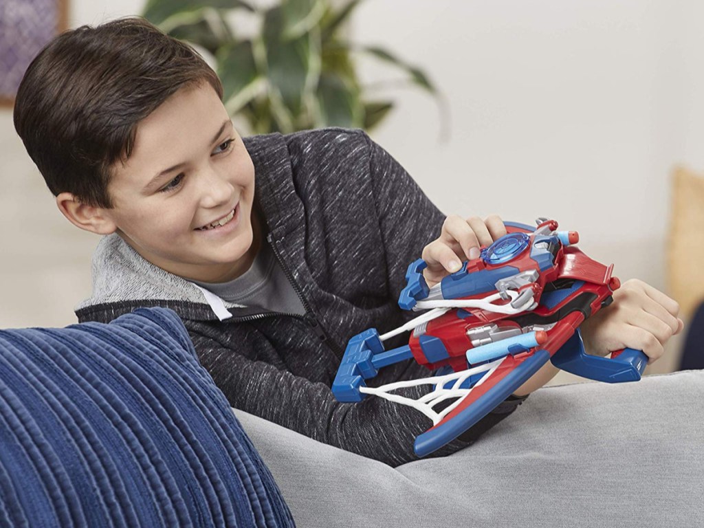 boy using spiderman toy