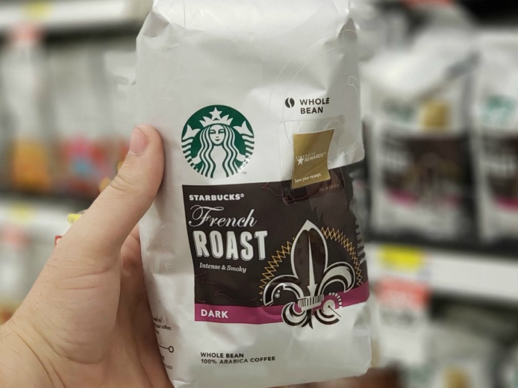 hand holding bag of dark roast coffee