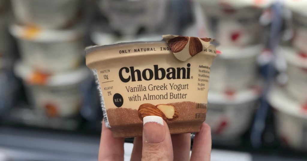 hand holding greek yogurt in a store