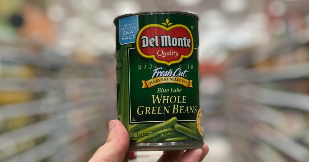 hand holding canned vegetables in a store