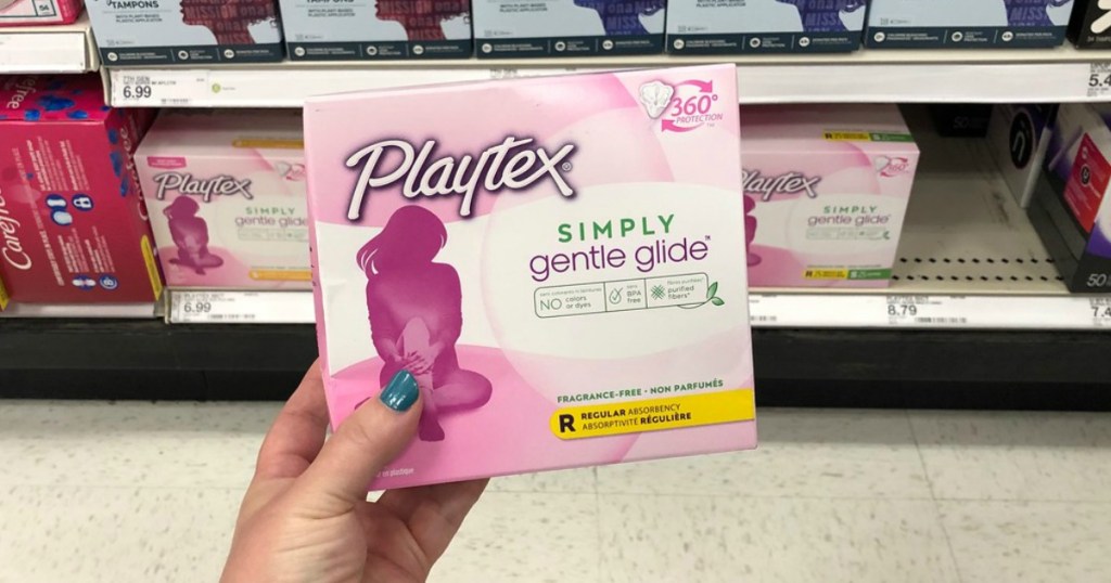 hand holding playtex simply gentle glide tampons in a store
