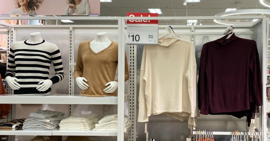 women's sweaters hanging in a store