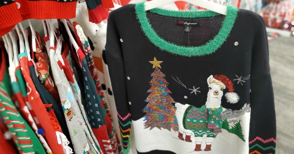 hand holding ugly holiday sweater in a store