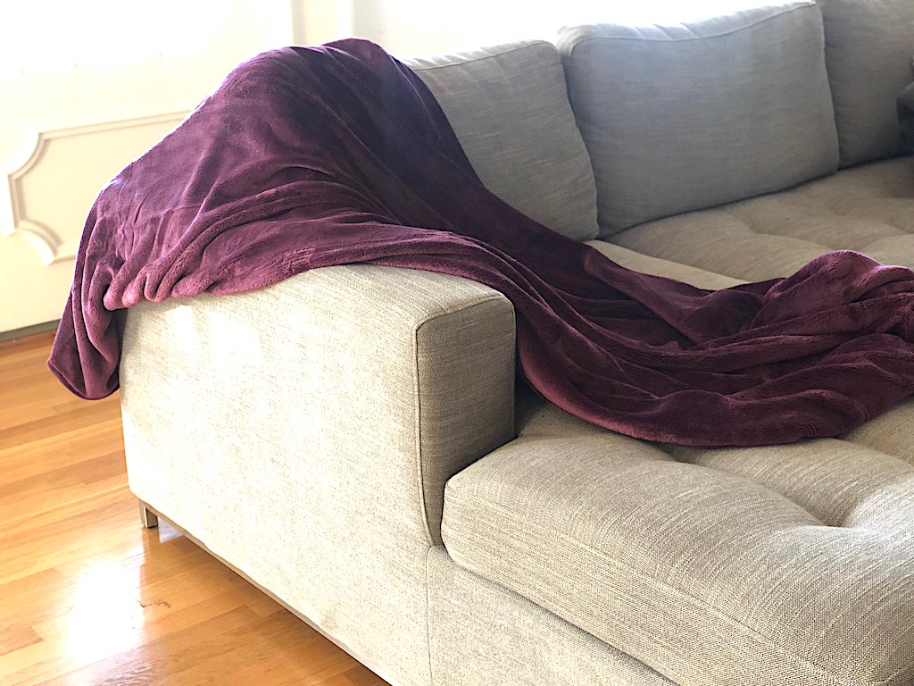 purple blanket draped on couch