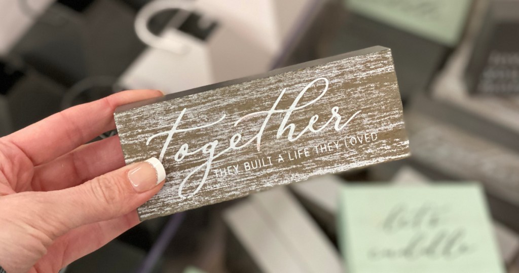 small wooden sign: "Together they built a life they loved"