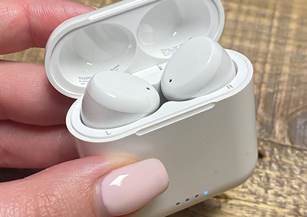 hand holding tozo wireless earbuds