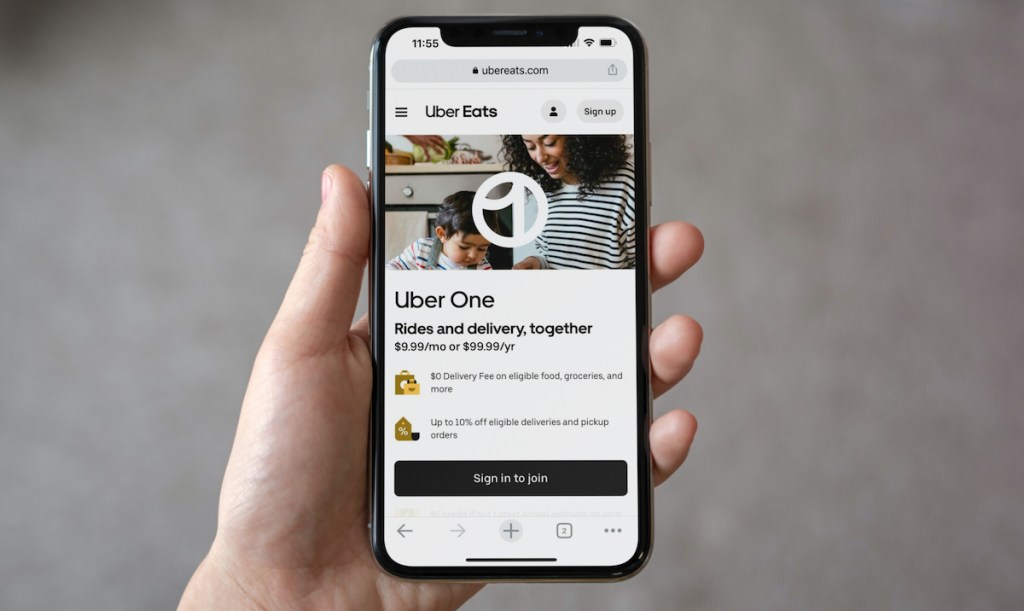 hand holding a phone with uber one promo on screen