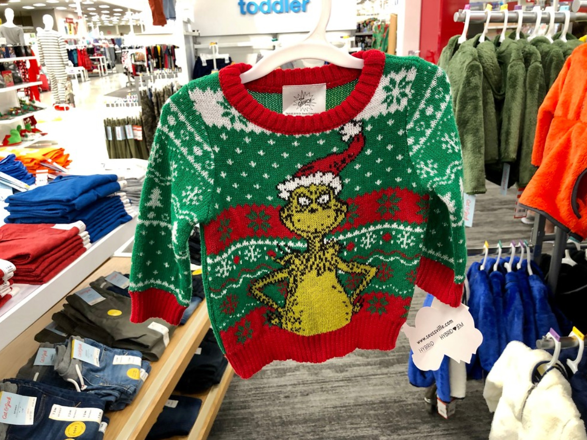 ugly christmas sweater grinch hanging in store