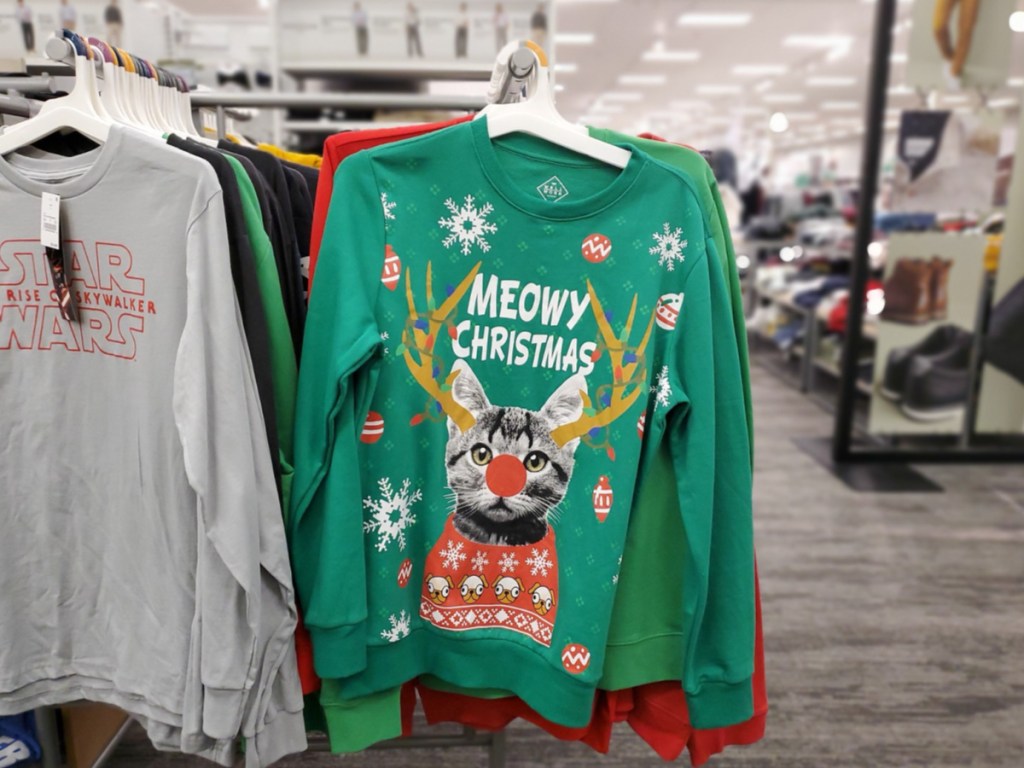 meowy christmas sweater hanging in store