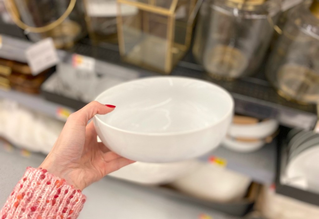 hand holding white serving bowl in store 