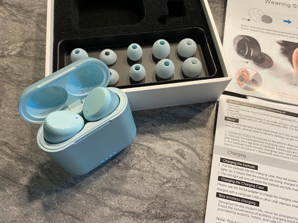 blue wireless earbuds with different size earpieces 
