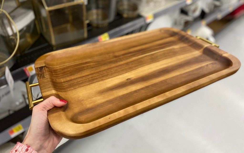 hand holding wood serving tray in store 