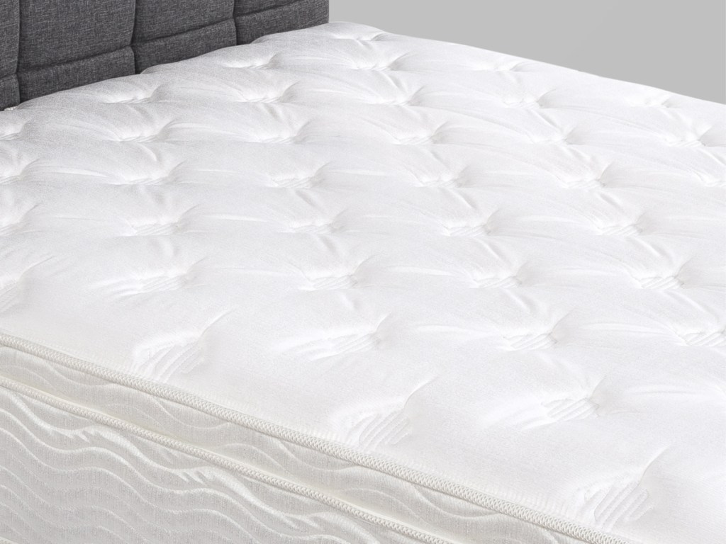 mattress with grey haeadboard