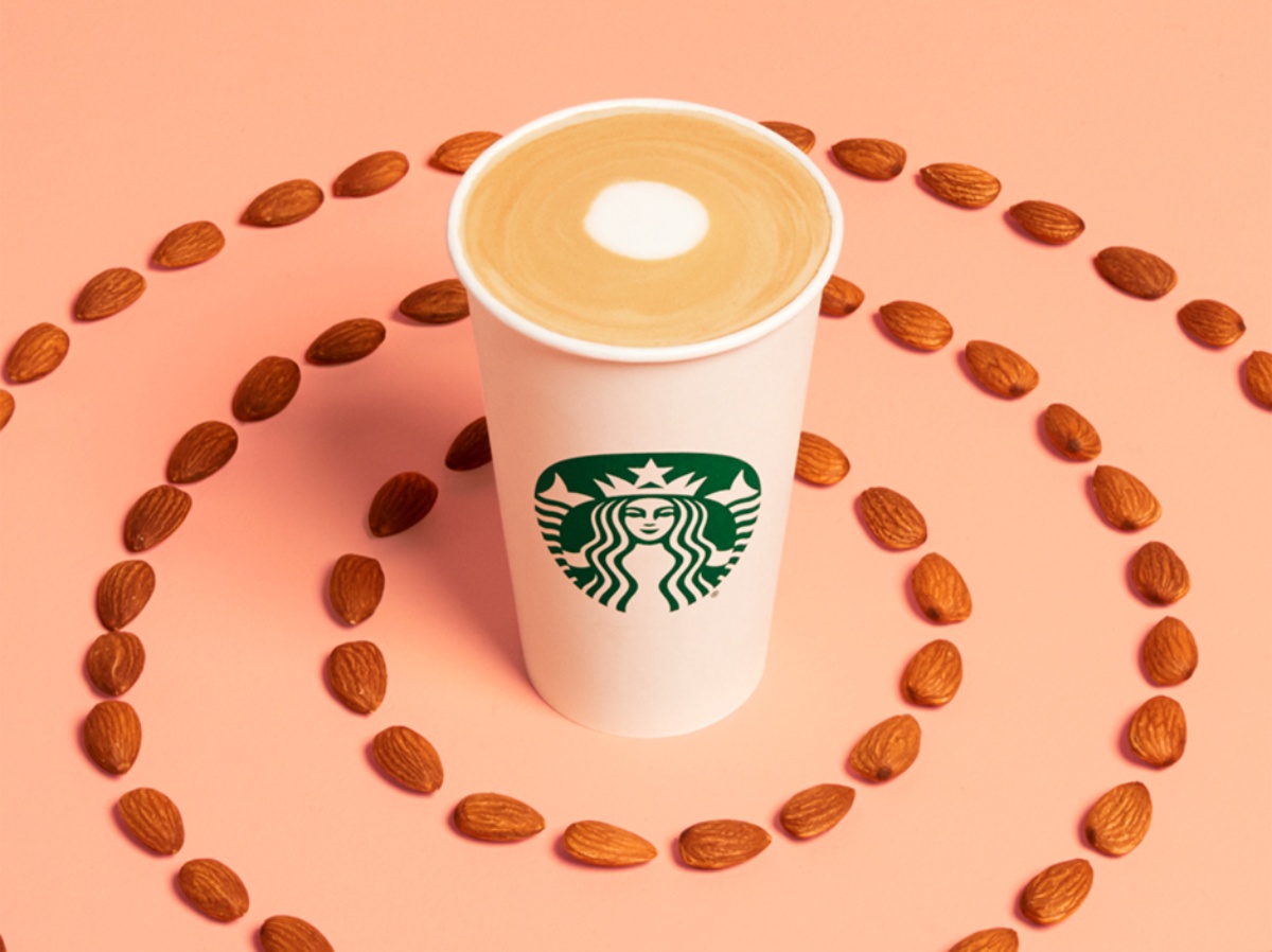Starbucks Almondmilk Honey Latte surounded by almonds