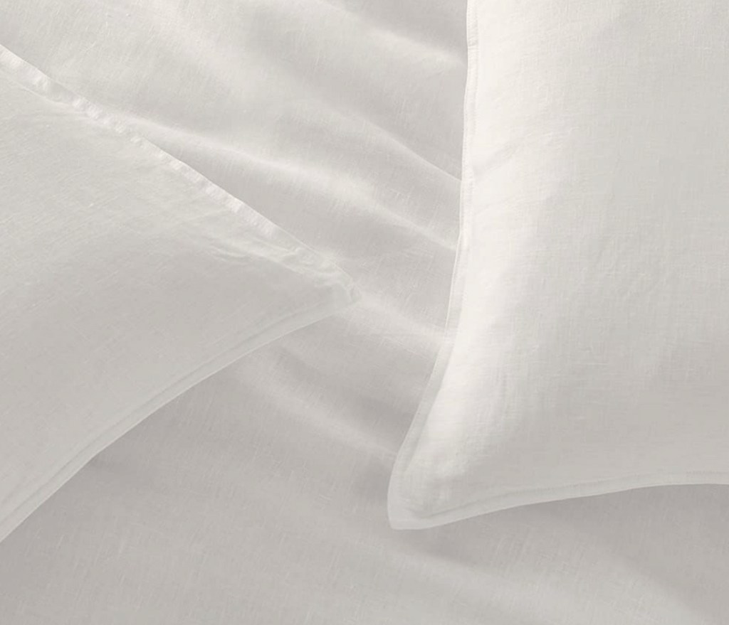 close up of white linen sheets and pillows