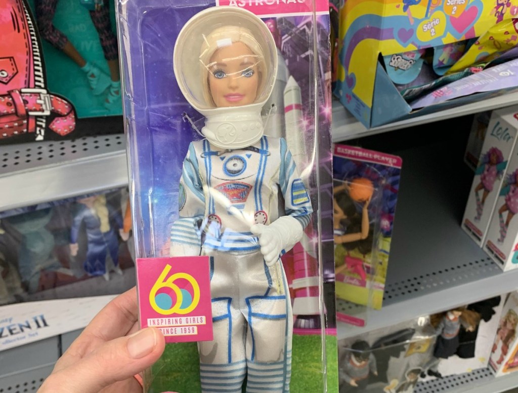 woman holding Astronaut Barbie doll