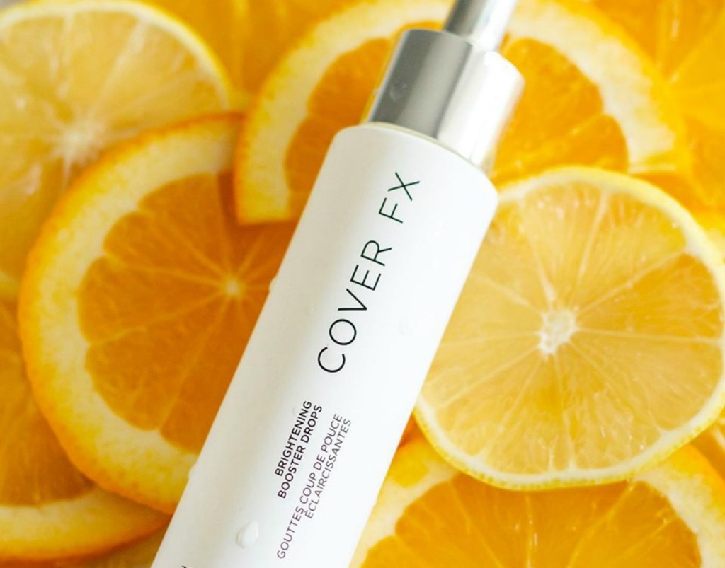 COVER FX Brightening Booster Drops on top of orange slices