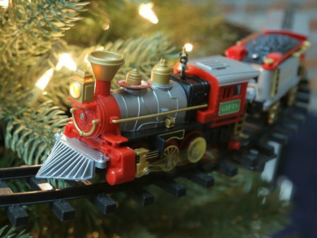 Small train driving around a Christmas tree