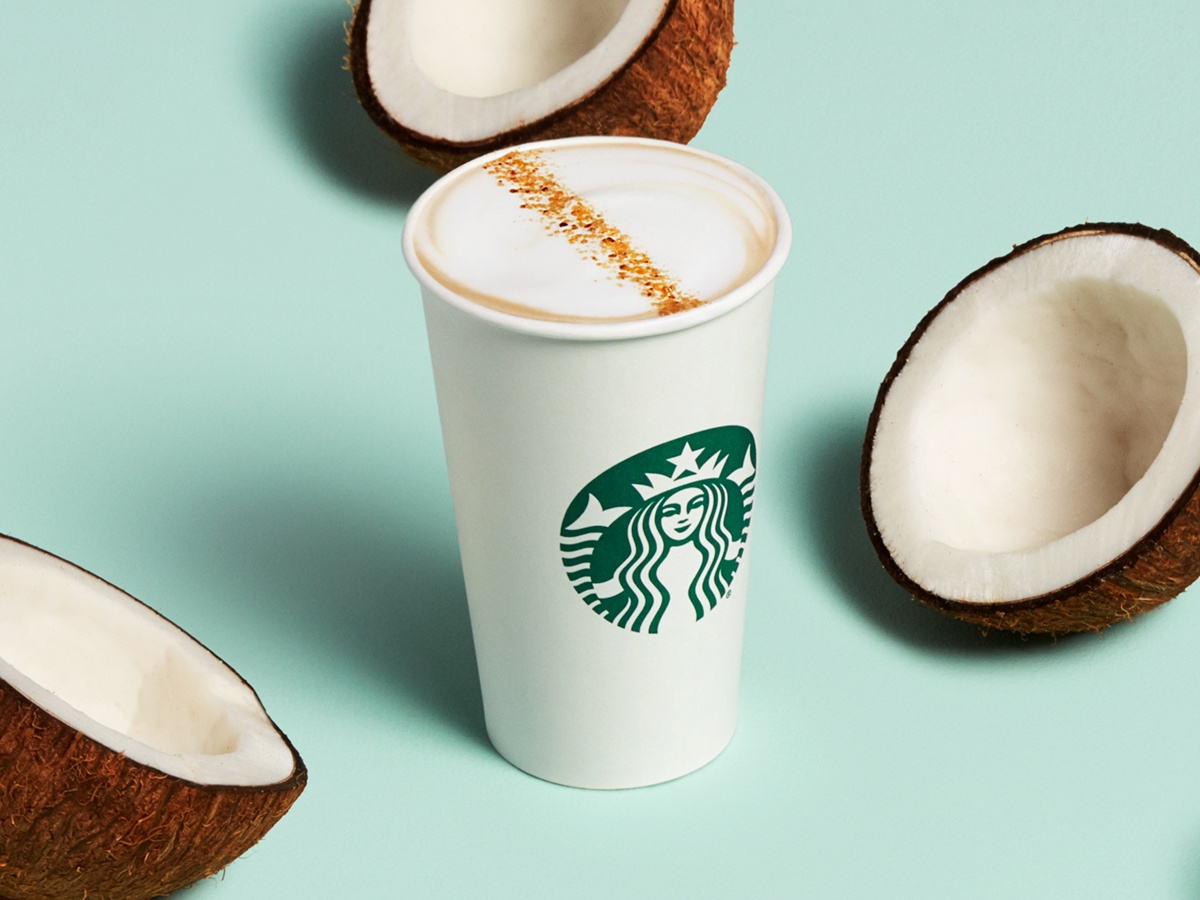 Starbucks Coconutmilk Latte surrounded by coconuts