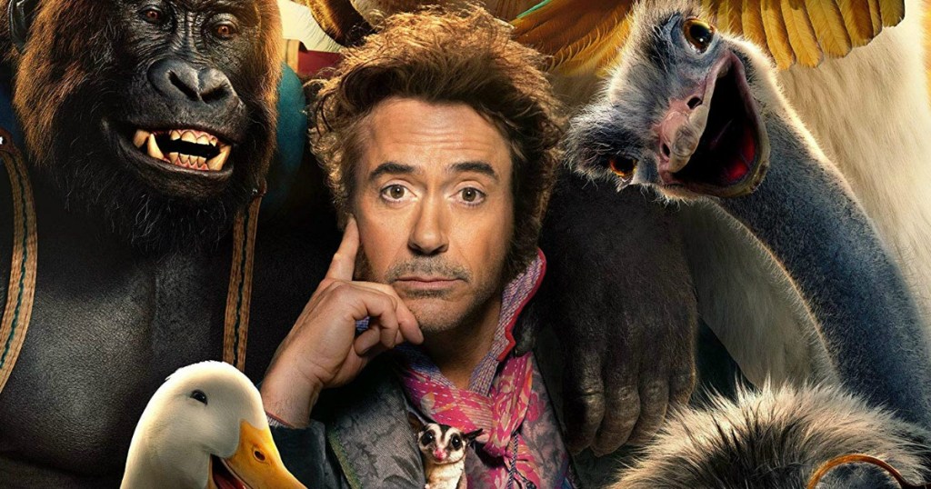 Man posing with a bunch of different kinds of animals on the Dolittle movie poster