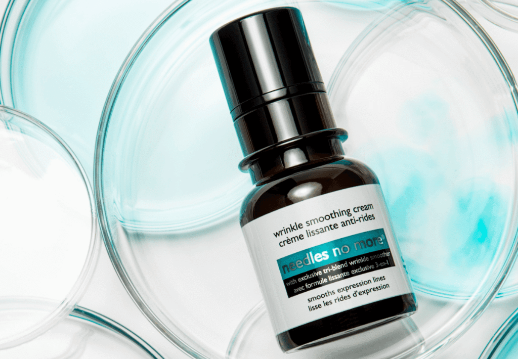 bottle of Dr. Brandt Needles No More Expression Line Smoother on round petri dishes