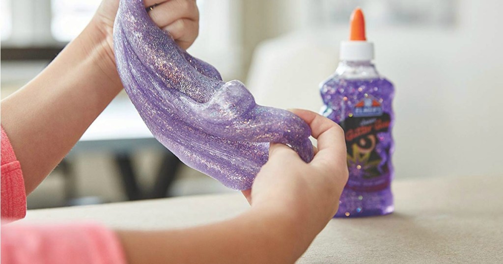 Girl making purple slime with Elmer's Glitter Glue