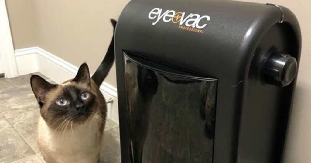 EyeVac Pro Vacuum with cat standing next to it