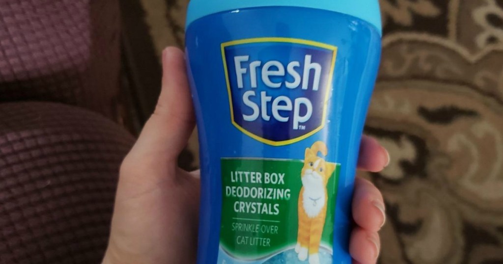 Fresh Step cat litter deodorizing crystals in hand