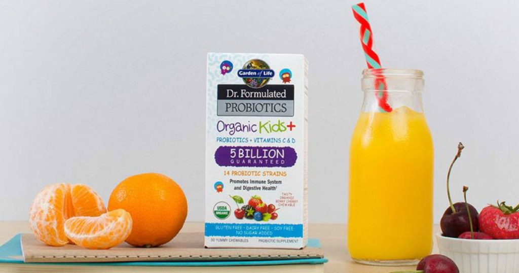 Garden of Life Kids probiotics next to orange juice and fruit