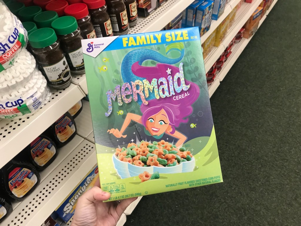 hand holding box of General Mills Mermaid cereal at Dollar Tree