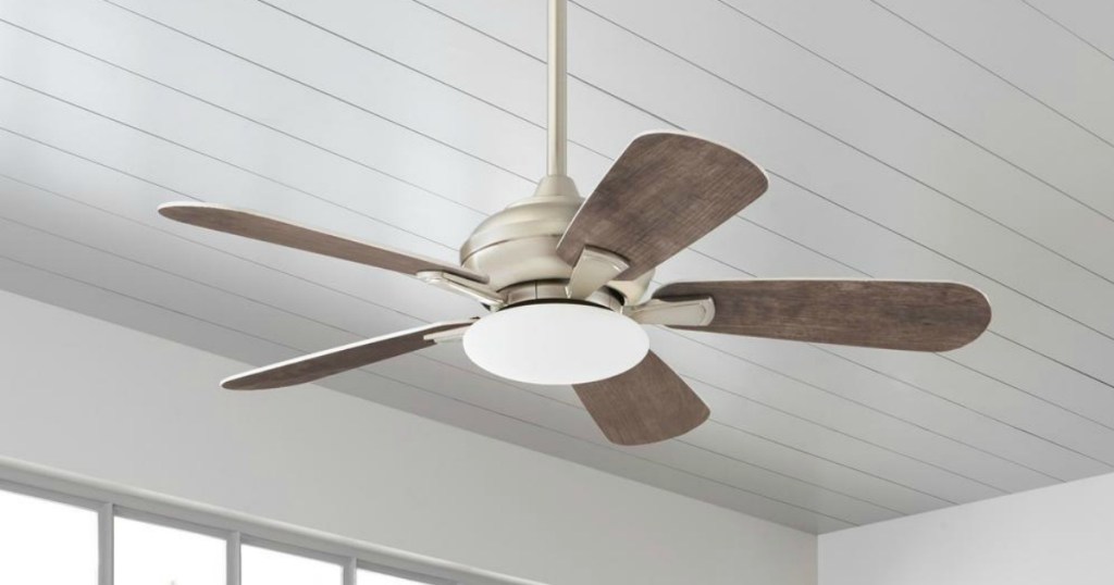 Large ceiling fan with light hanging on entryway ceiling