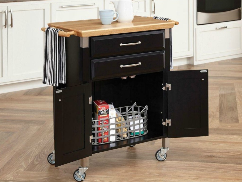 black kitchen cart with light wooden counter top and cupboard doors