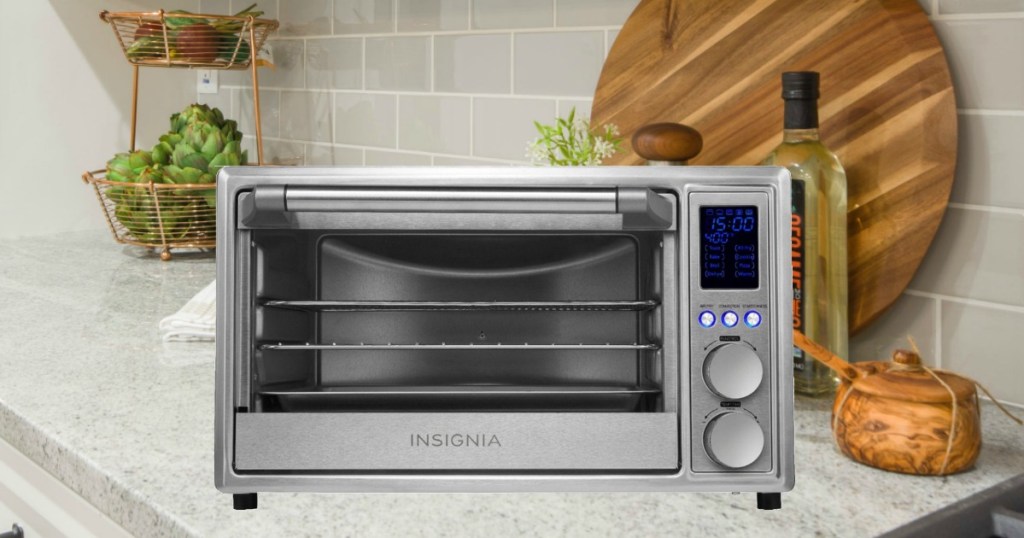 Insignia 6-Slice Toaster Oven on counter near olive oils and cutting boards