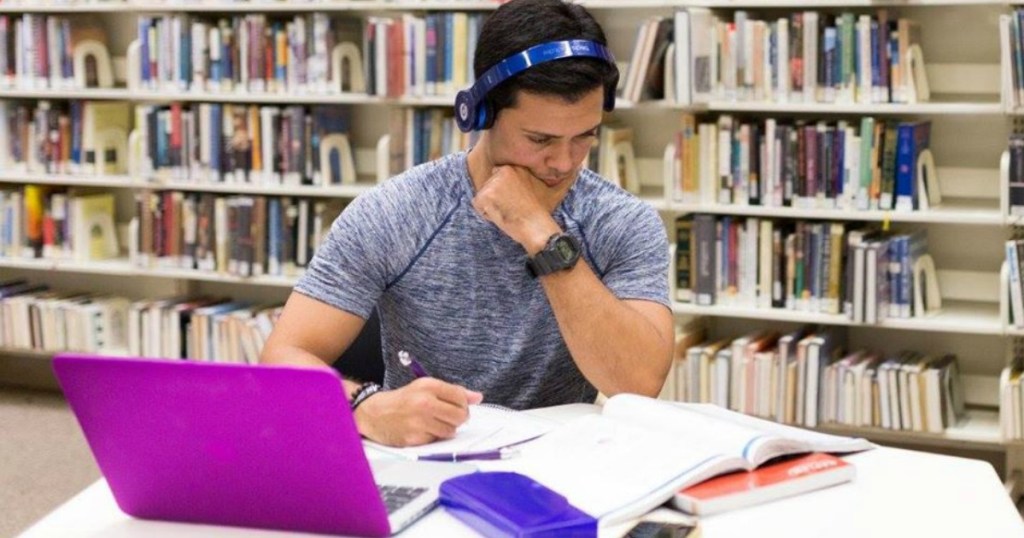 person sitting in library preparing for exam