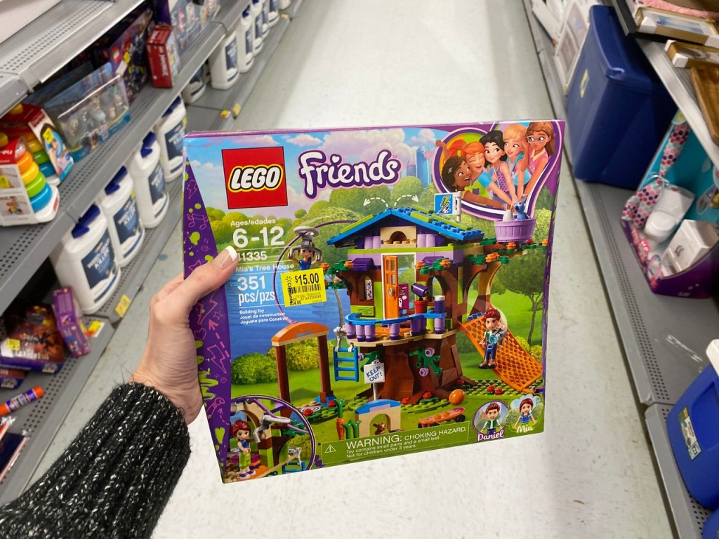 Hand holding LEgo Friends Tree House in Walmart Aisle