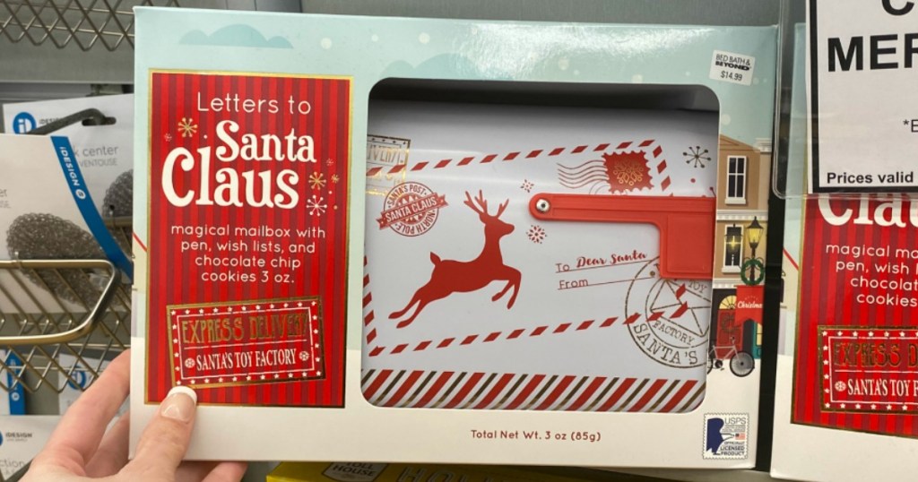 hand holding a Letters to Santa Claus Mailbox